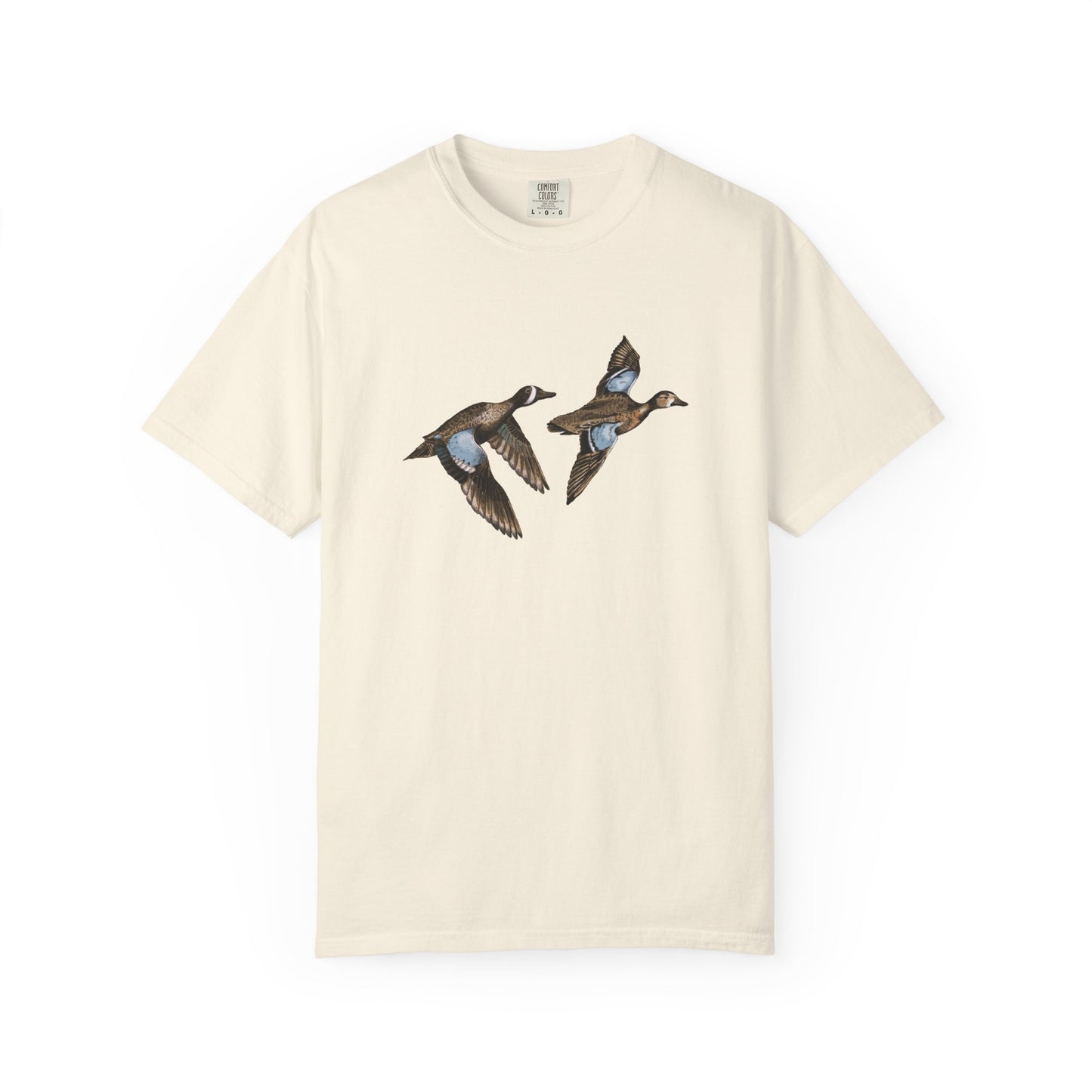A ivory t-shirt featuring an illustration of two blue-winged teal birds in flight.